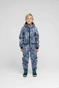 Softshell Onesie for Kids worn by a child featuring blue print, adjustable hood, and zippered pockets.
