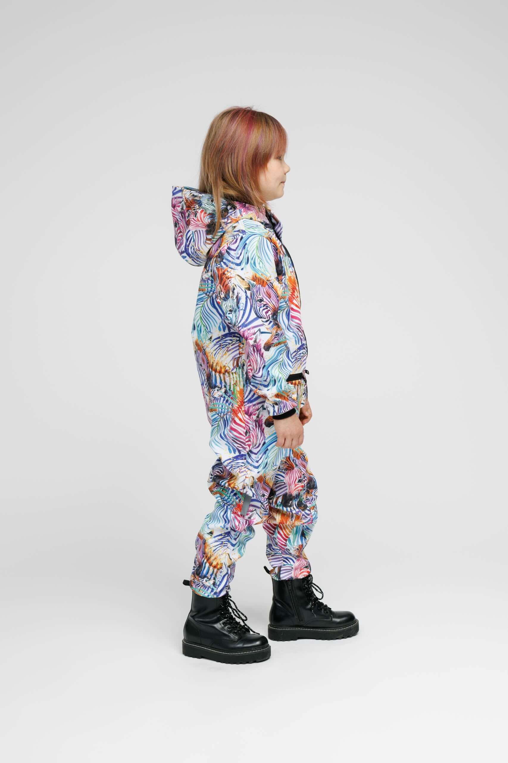 Child wearing a colorful softshell onesie, showcasing its weather-resistant kids onesie features and stylish design.