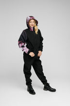 Softshell Onesie for Kids on a child wearing a stylish, weather-resistant outfit with a colorful hood.
