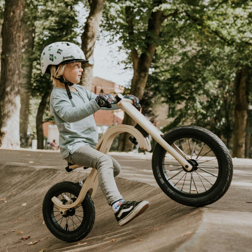 Child riding leg&go Balance Bike, showcasing balancing skills on a smooth surface outdoors.