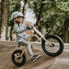 Child riding leg&go Balance Bike, showcasing balancing skills on a smooth surface outdoors.