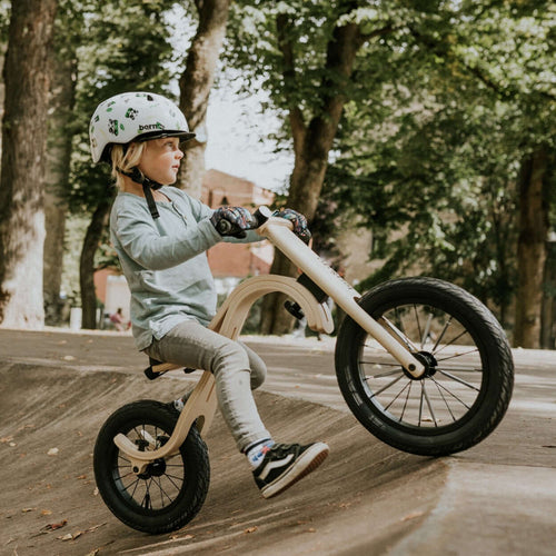 Child riding leg&go Balance Bike, showcasing balancing skills on a smooth surface outdoors.