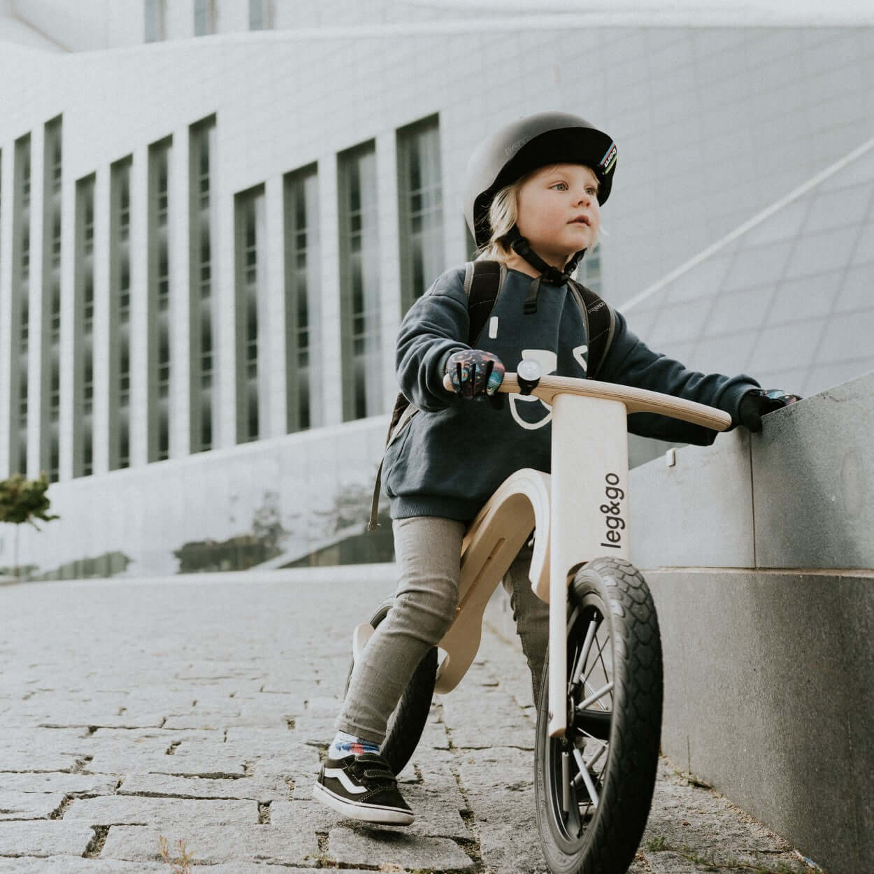 A child riding a leg&go Balance Bike 3in1, showcasing sustainable wooden design and innovative features for growing kids.