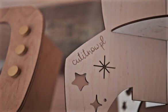 close-up of the rocket shelf space decor detailing with stars and logo on wooden material