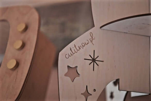 close-up of the rocket shelf space decor detailing with stars and logo on wooden material