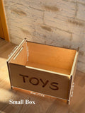 Montessori wooden toy box with open top and engraved 'TOYS', perfect for stylish nursery storage.