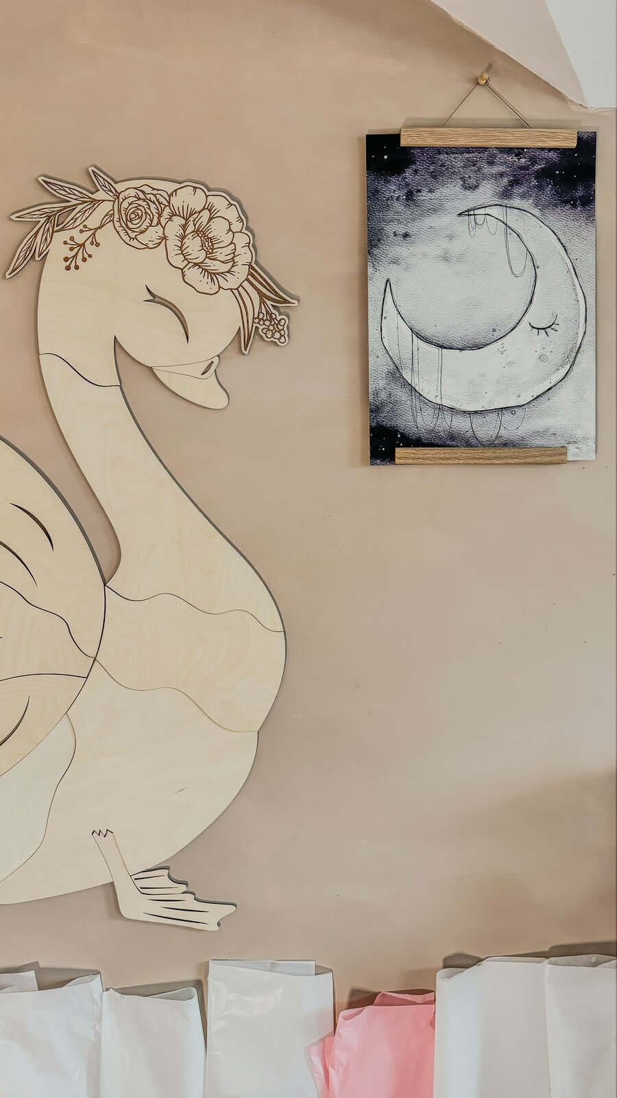 unique wooden wall decoration featuring a swan design made of high-quality plywood, hanging beside an art piece.