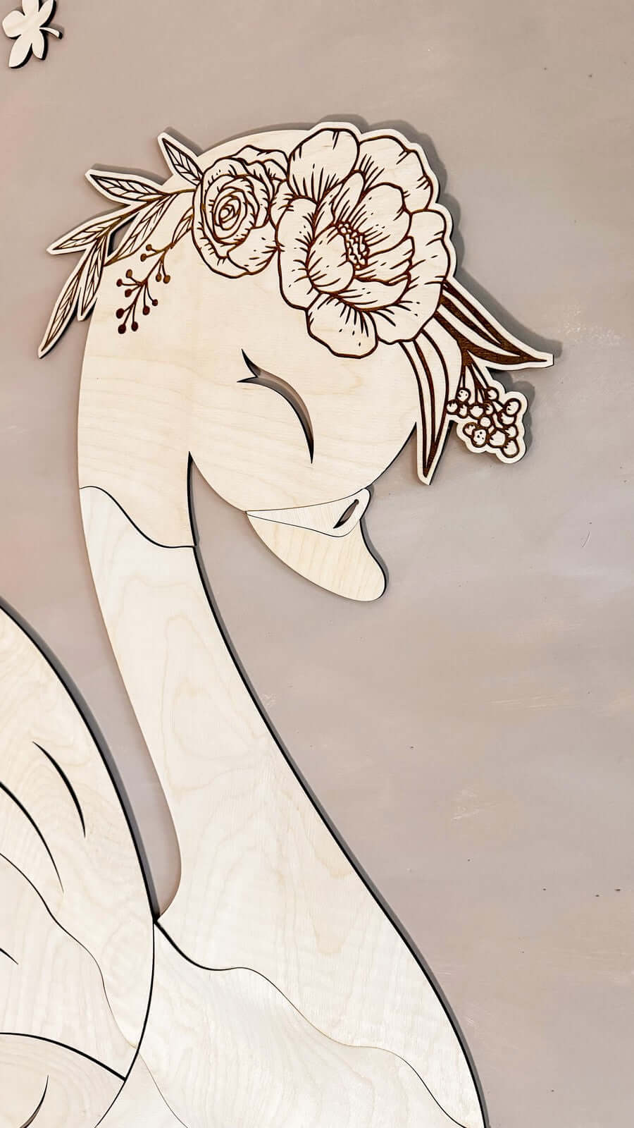Unique wooden wall decoration featuring a beautifully crafted swan with floral details.